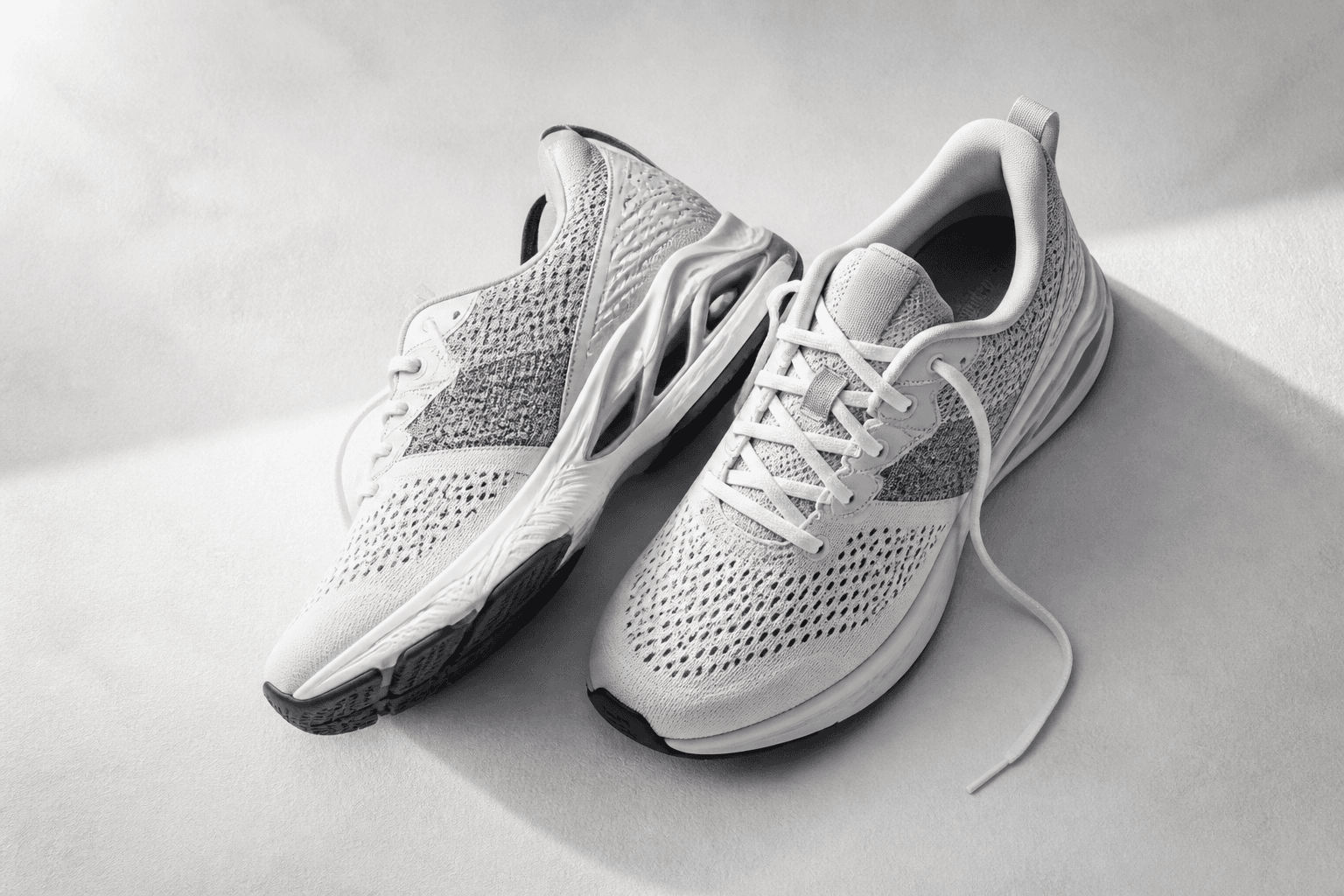 Modern cushioned running shoes on a studio surface
